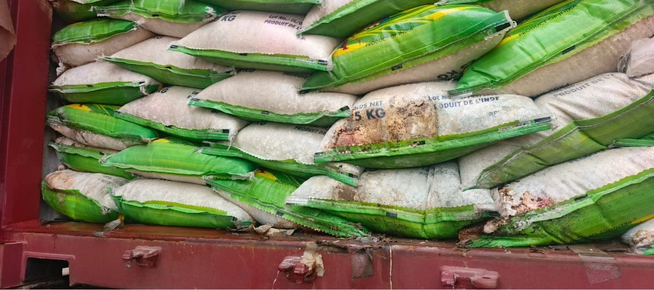 Stacked rice bags showing visible damage and staining
